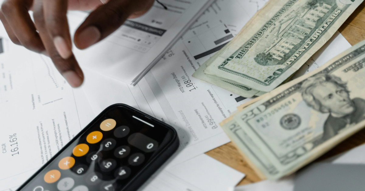 a person reviews their account statements, using their phone as a calculator