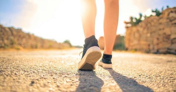 feet stepping forward on a gravel road