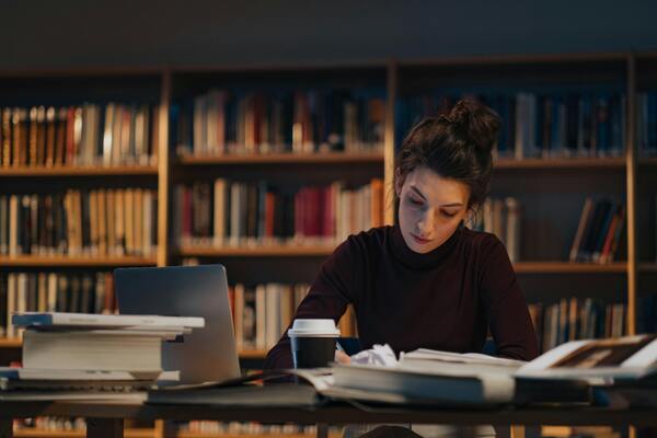 a young woman works in a college library